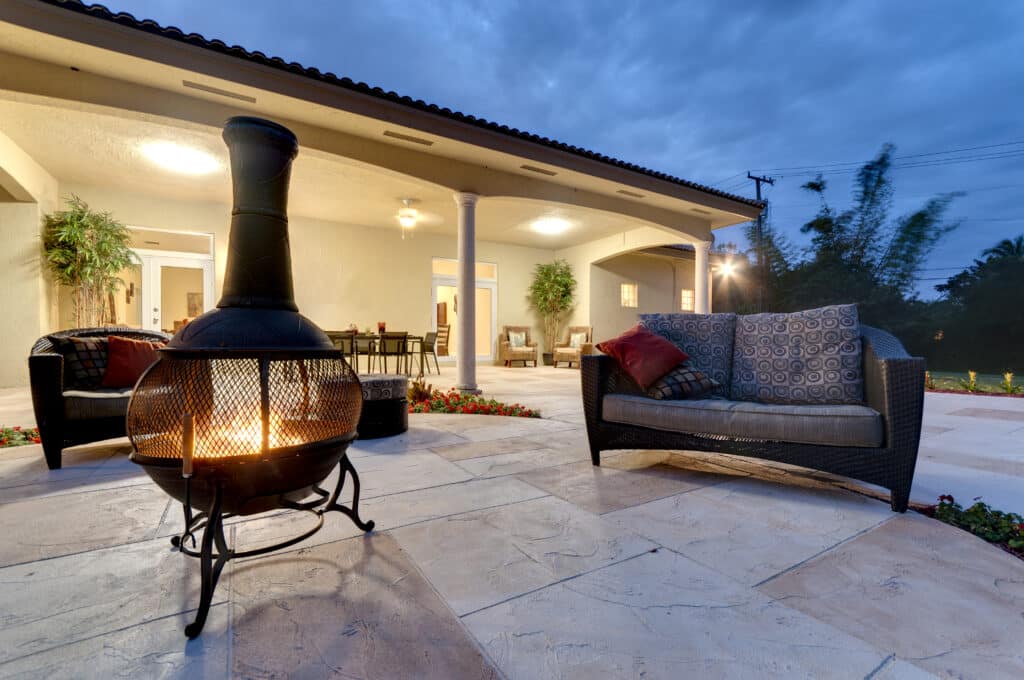 7 Ways to Spruce Up Your Patio in Summer Fire pit in a modern backyard with patio furniture. Your Patio in Summer